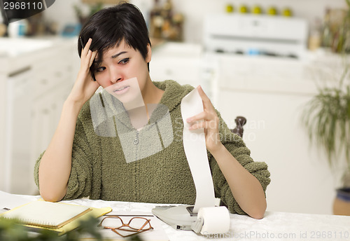 Image of Multi-ethnic Young Woman Agonizing Over Financial Calculations