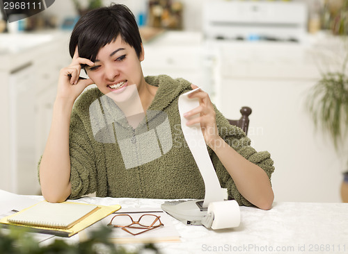 Image of Multi-ethnic Young Woman Agonizing Over Financial Calculations