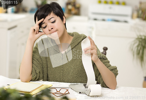 Image of Multi-ethnic Young Woman Agonizing Over Financial Calculations