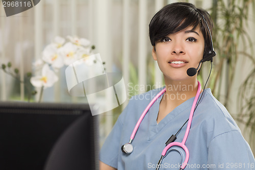 Image of Mixed Race Female Nurse Practitioner or Doctor at Computer