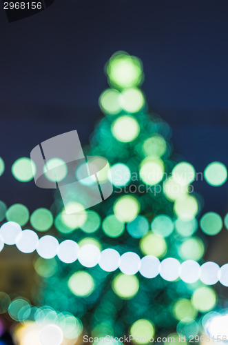 Image of Decorated Christmas tree. Abstract blurred lights background