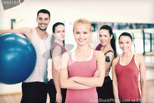 Image of woman standing in front of the group in gym