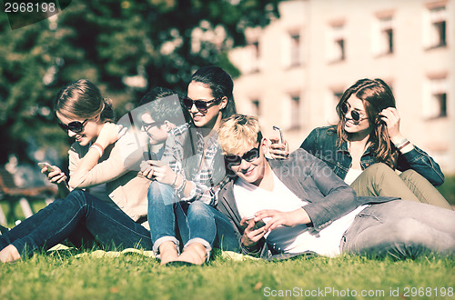 Image of students looking at smartphones and tablet pc