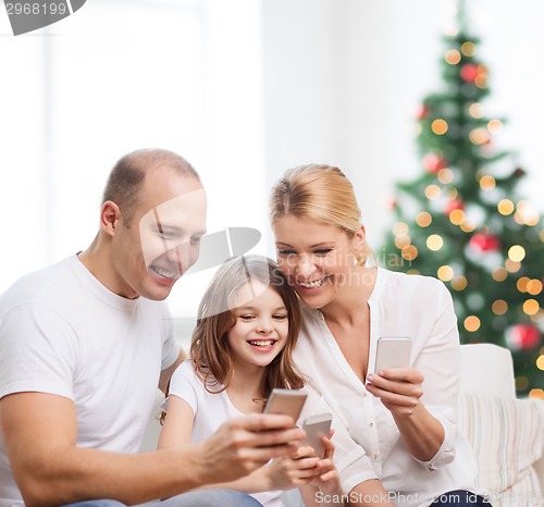 Image of happy family with smartphones