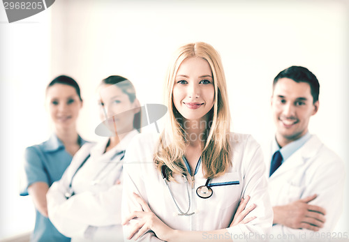 Image of female doctor in front of medical group