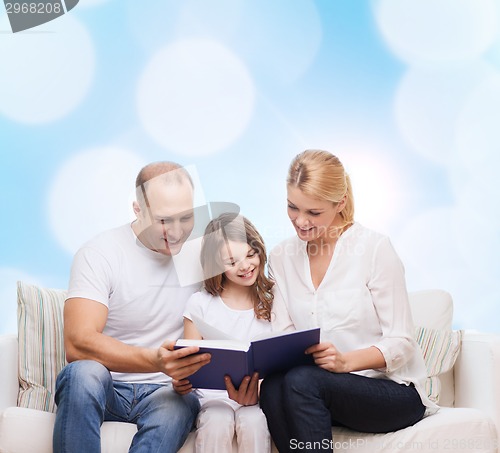 Image of happy family with book at home