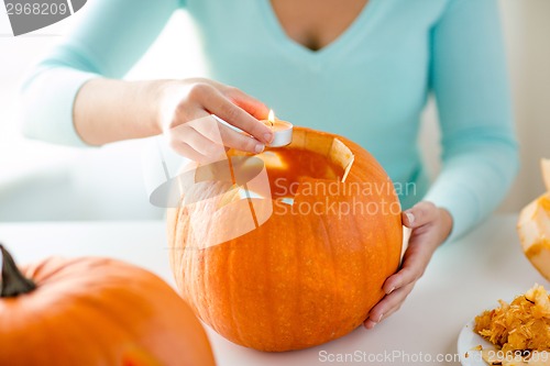 Image of close up of woman with pumpkins at home