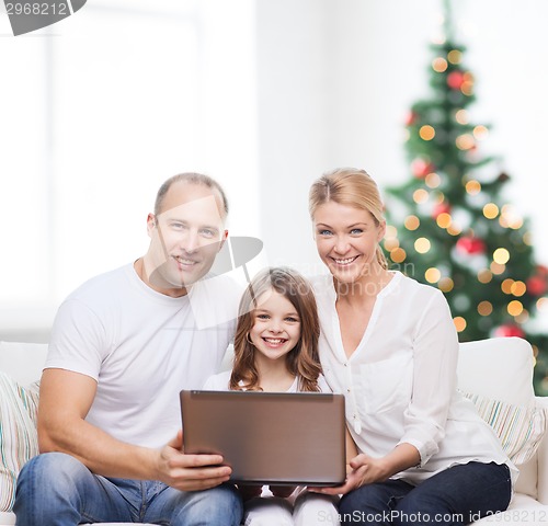 Image of happy family with laptop computer