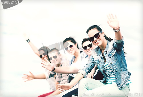 Image of group of teenagers waving hands