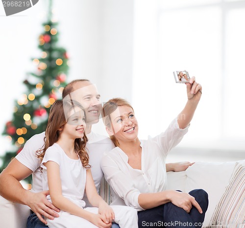 Image of happy family with camera at home