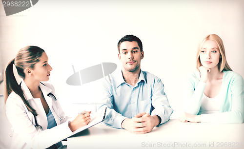 Image of doctor with patients in cabinet