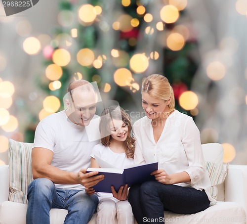 Image of happy family with book at home