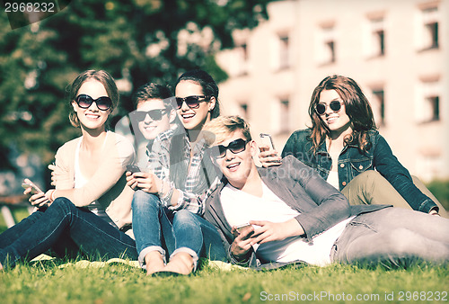 Image of students looking at smartphones and tablet pc