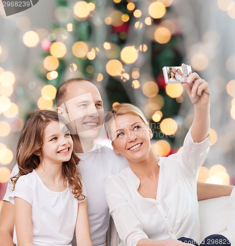 Image of happy family with camera at home
