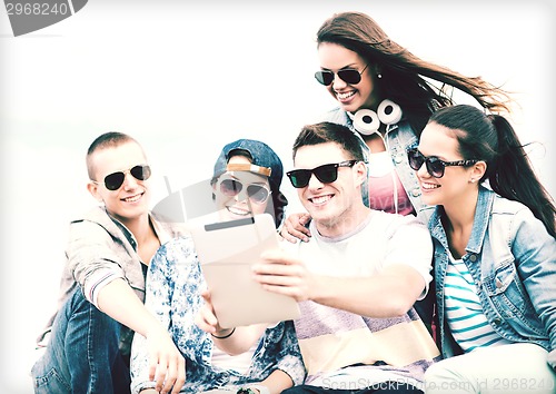 Image of group of teenagers looking at tablet pc