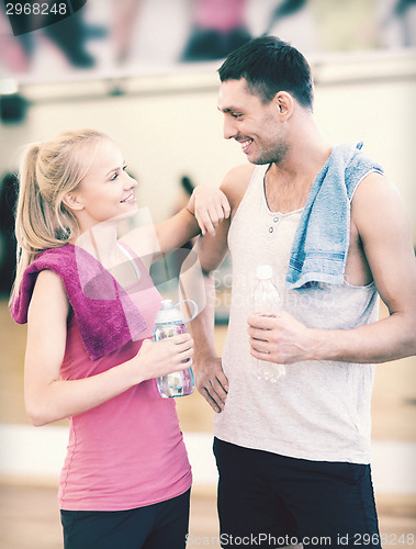 Image of two smiling people in the gym