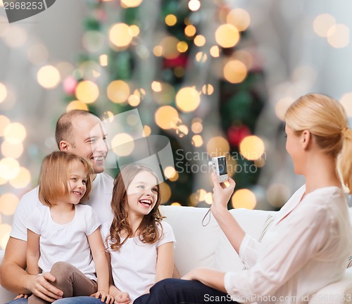 Image of happy family with camera at home