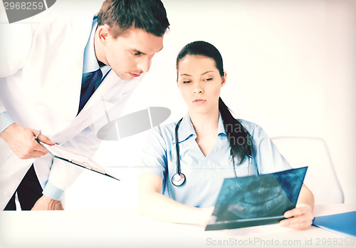 Image of two medical workers looking at x-ray