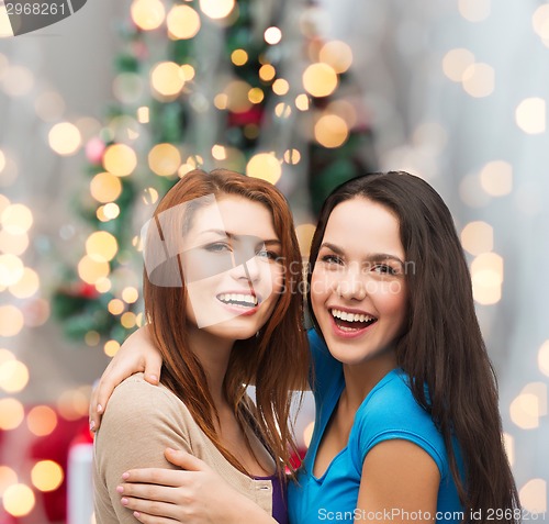Image of smiling teenage girls hugging