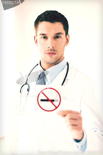 Image of male doctor holding no smoking sign