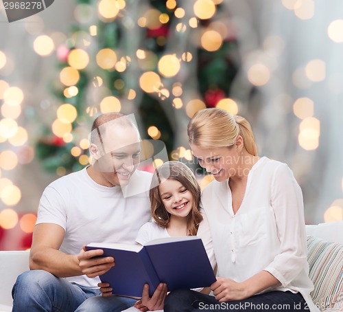 Image of happy family with book at home