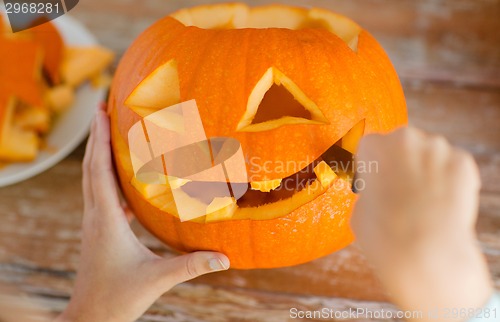 Image of close up of woman with pumpkins at home