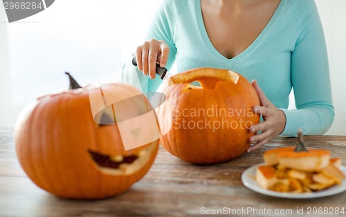 Image of close up of woman with pumpkins at home