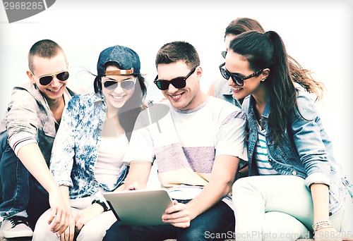 Image of group of teenagers looking at tablet pc