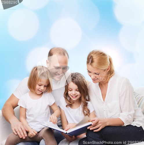 Image of happy family with book at home