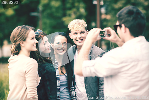 Image of teenagers taking photo outside