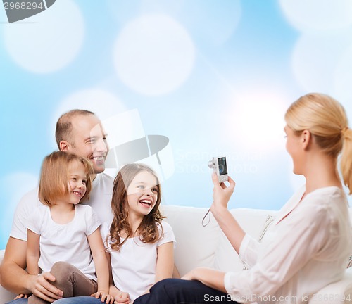 Image of happy family with camera at home