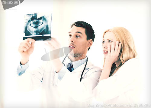 Image of two doctors looking at x-ray