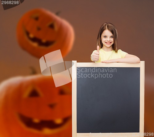 Image of smiling little girl with blackboard