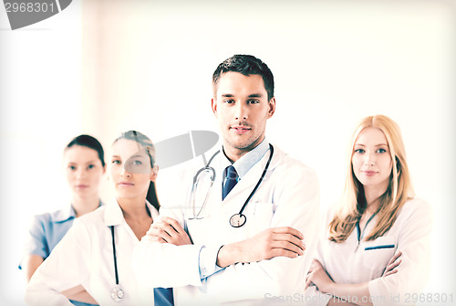 Image of male doctor in front of medical group