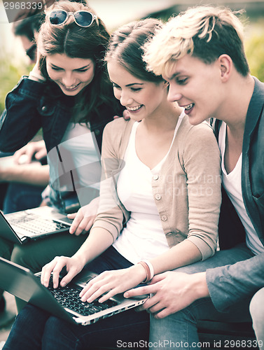 Image of students or teenagers with laptop computers