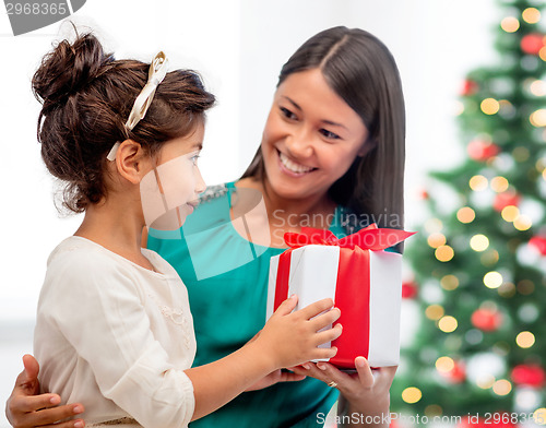 Image of happy mother and child girl with gift box