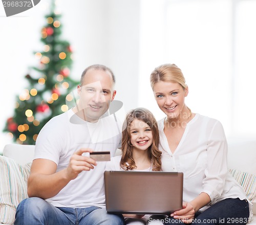 Image of happy family with laptop computer