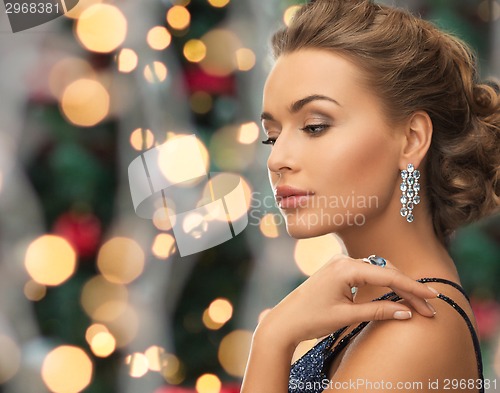 Image of beautiful woman wearing ring and earrings