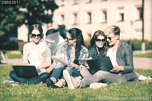 Image of students or teenagers with laptop computers