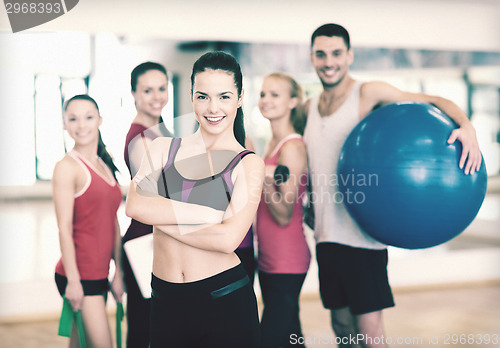 Image of woman standing in front of the group in gym