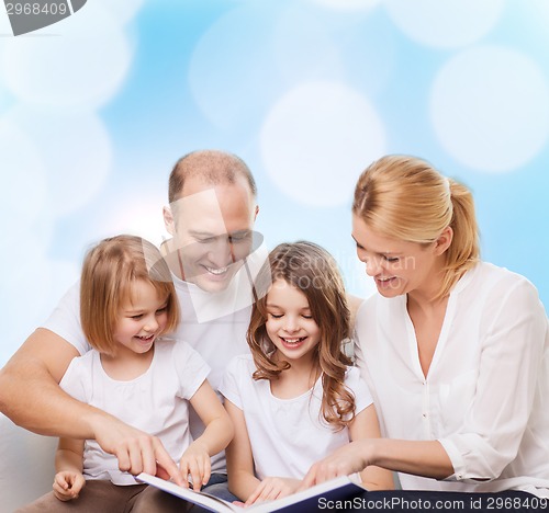 Image of happy family with book at home