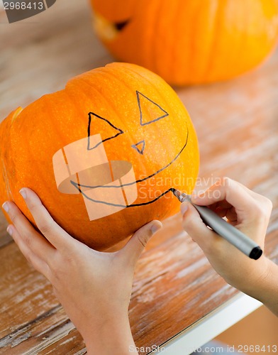 Image of close up of woman with pumpkins at home