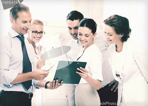 Image of business team discussing something in office