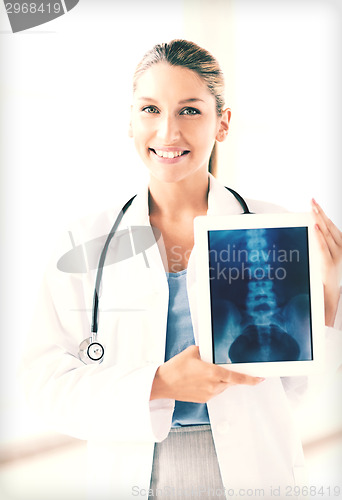 Image of female doctor with x-ray on tablet pc