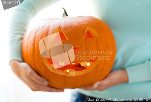 Image of close up of woman with pumpkins at home