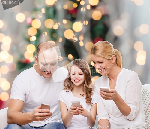 Image of happy family with smartphones