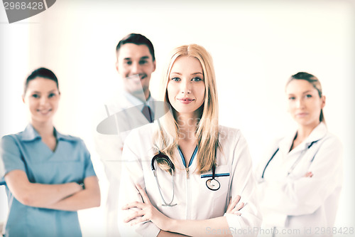 Image of female doctor in front of medical group