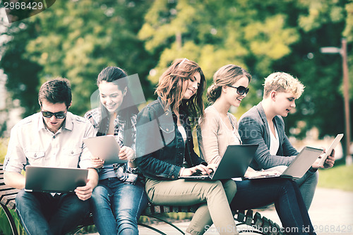 Image of students or teenagers with laptop computers