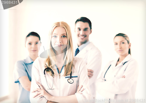 Image of female doctor in front of medical group