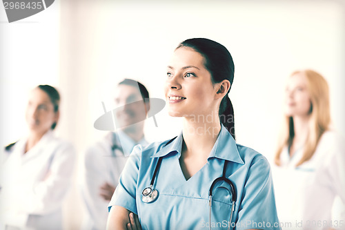 Image of female doctor in front of medical group